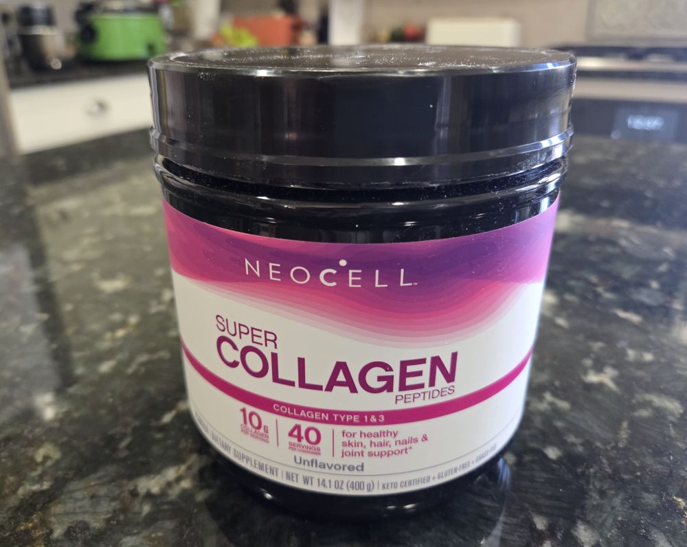 A tub of Neocell brand collagen powder atop a kitchen counter
