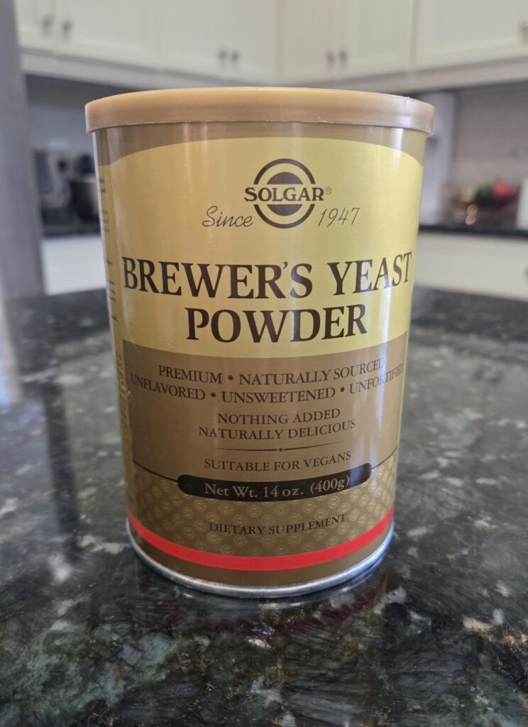 A can of Solgar brand brewer's yeast powder atop a kitchen counter