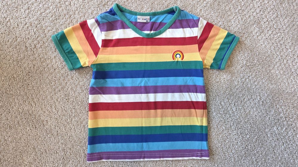 Top-down view of a colourful rainbow-striped toddler tee-shirt
