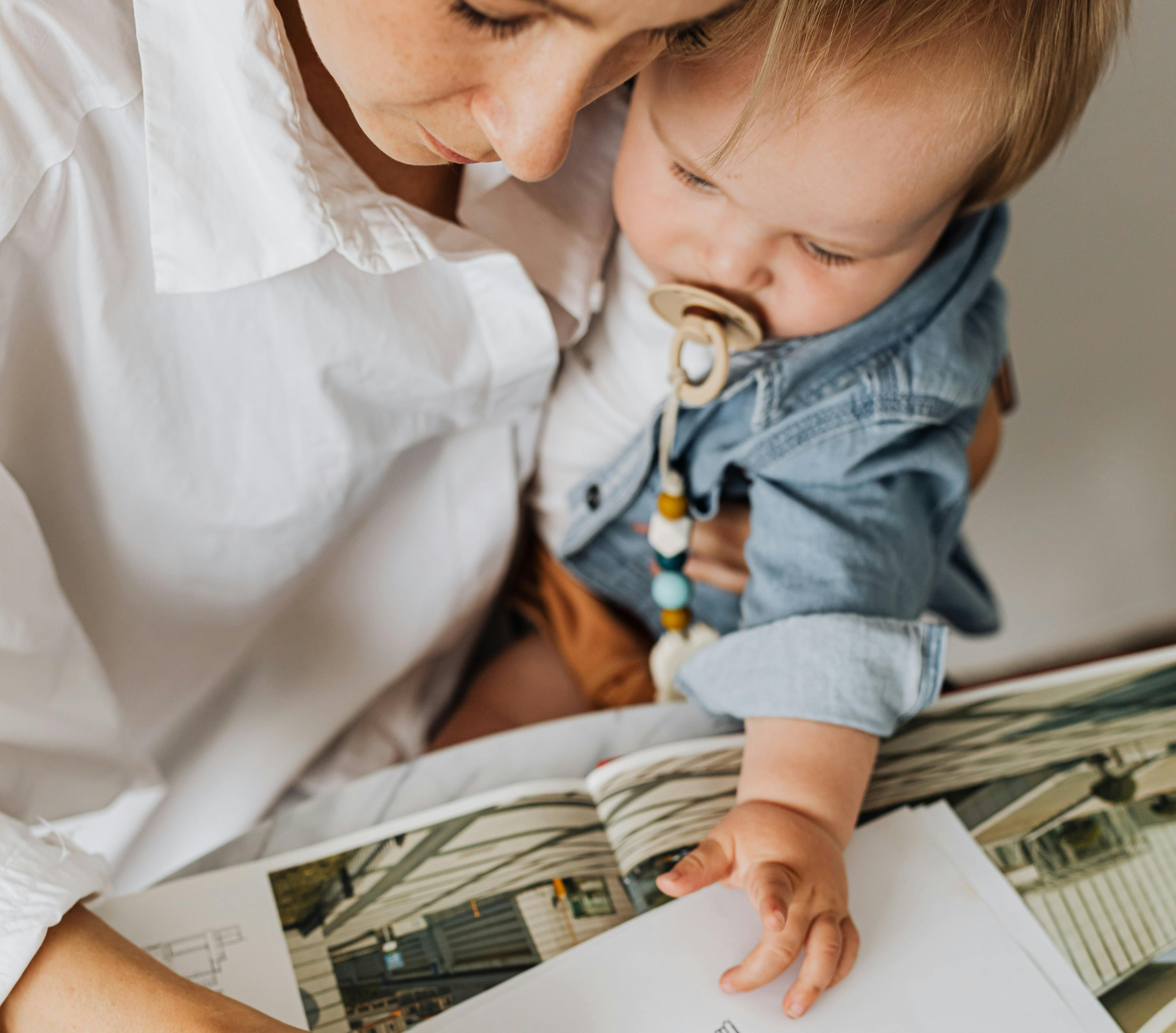 A mom holds her baby boy close while writing