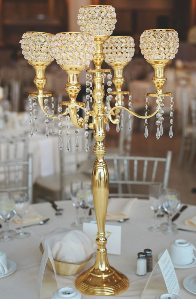 A crystal and gold-coloured brass candelabra tops a table as a centerpiece